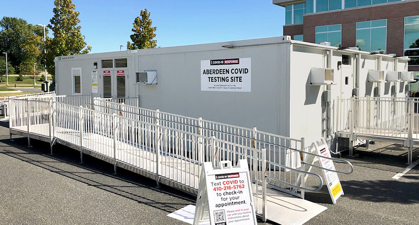 Line of mobile office trailers outside Chesapeake Hospital with sign stating "Aberdeen Covid Testing Site."