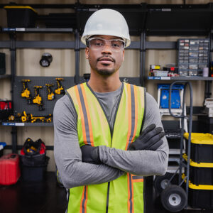 Worker in storage container wearing safety gear standing in front of a PRORACK™ system